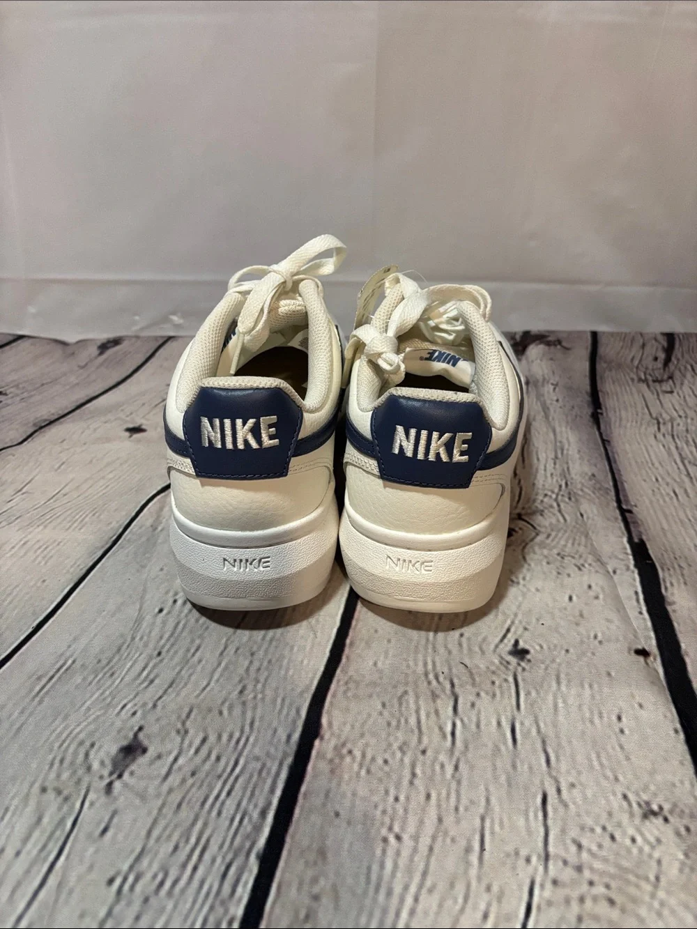 Nike Men’s White Leather Sneakers with Navy Swoosh Accent